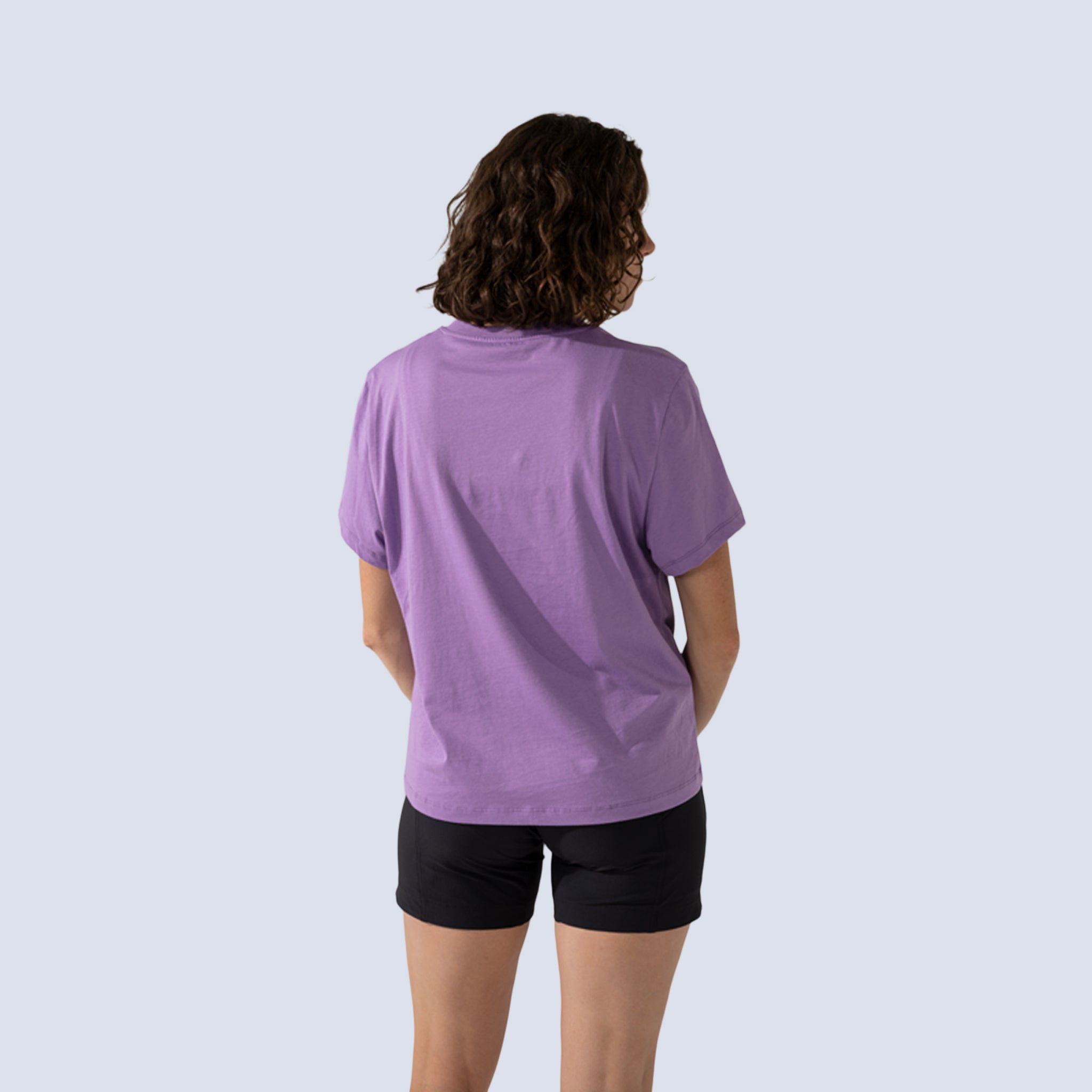 Woman wearing purple t-shirt back view