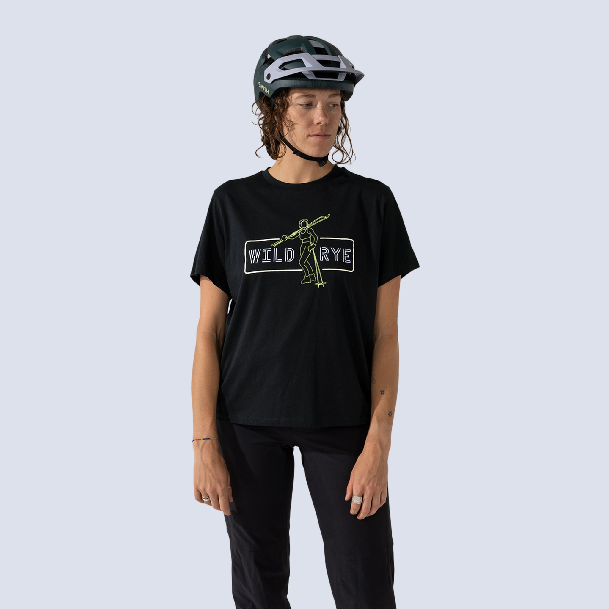 Woman wearing black t-shirt with 'Wild Rye' text and a graphic of a skier on the front