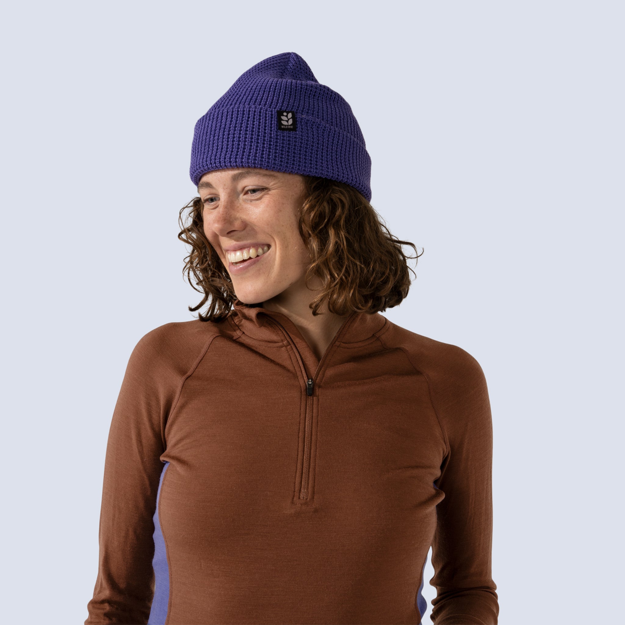 [Iris] Person wearing a brown long-sleeve shirt and iris dark purple beanie