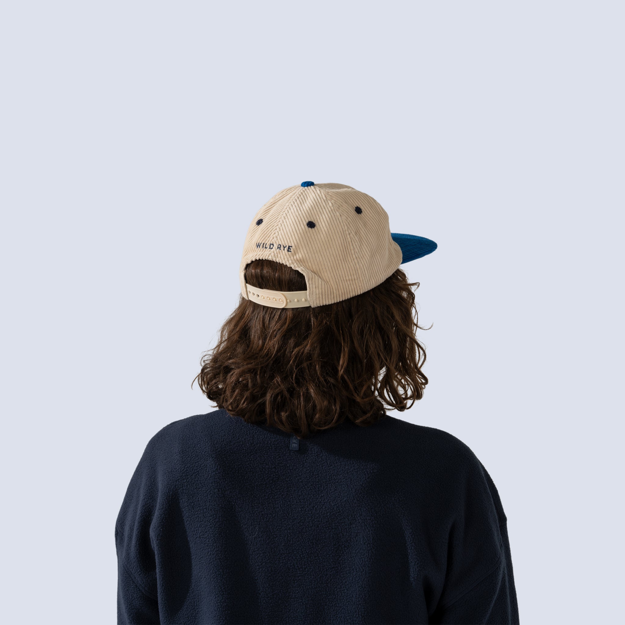 Back view of blue and white corduroy baseball cap
