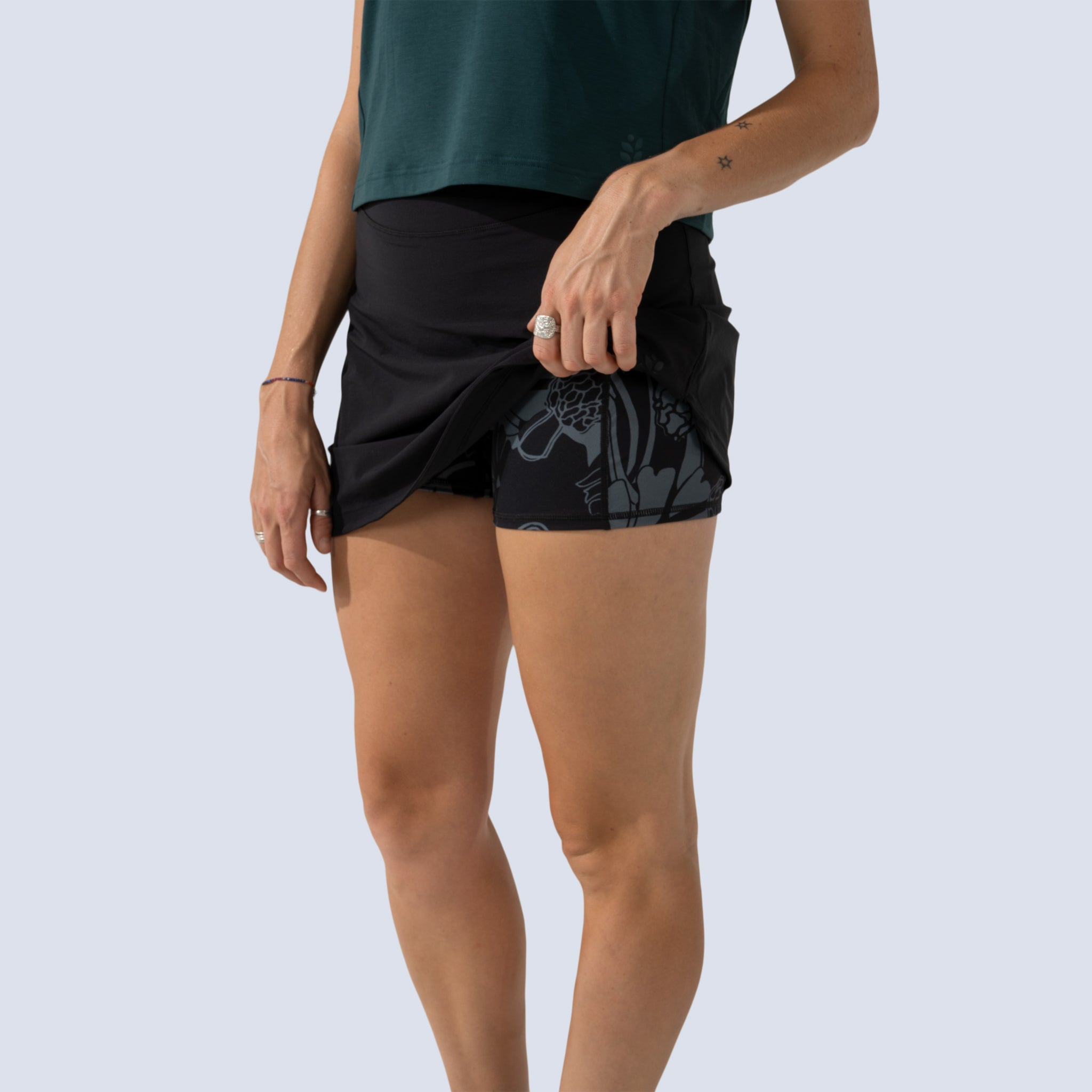 [Black] detail view of printed built in shorts under black parker skort