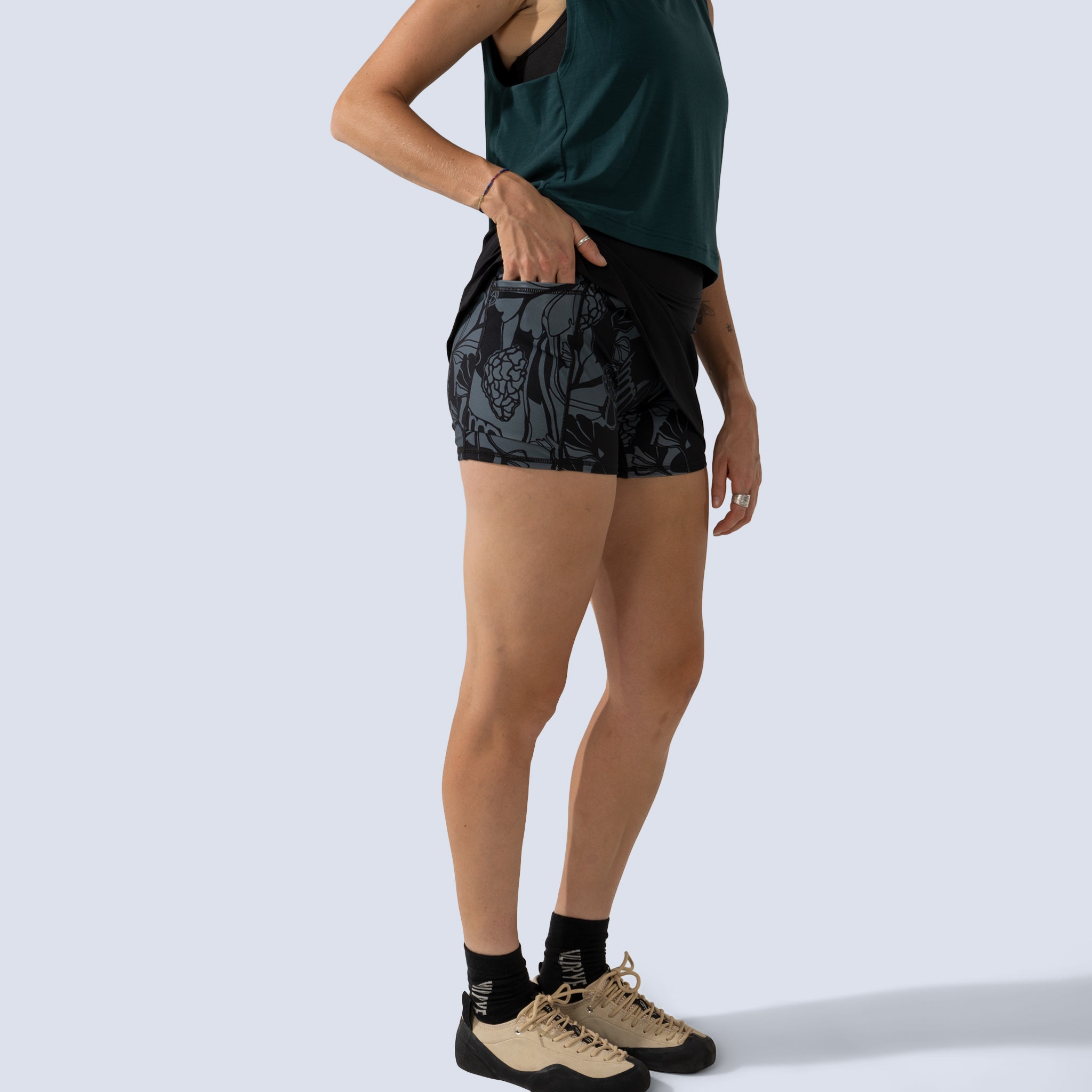 [Black] detail view of pocket on printed built in shorts under black parker skort