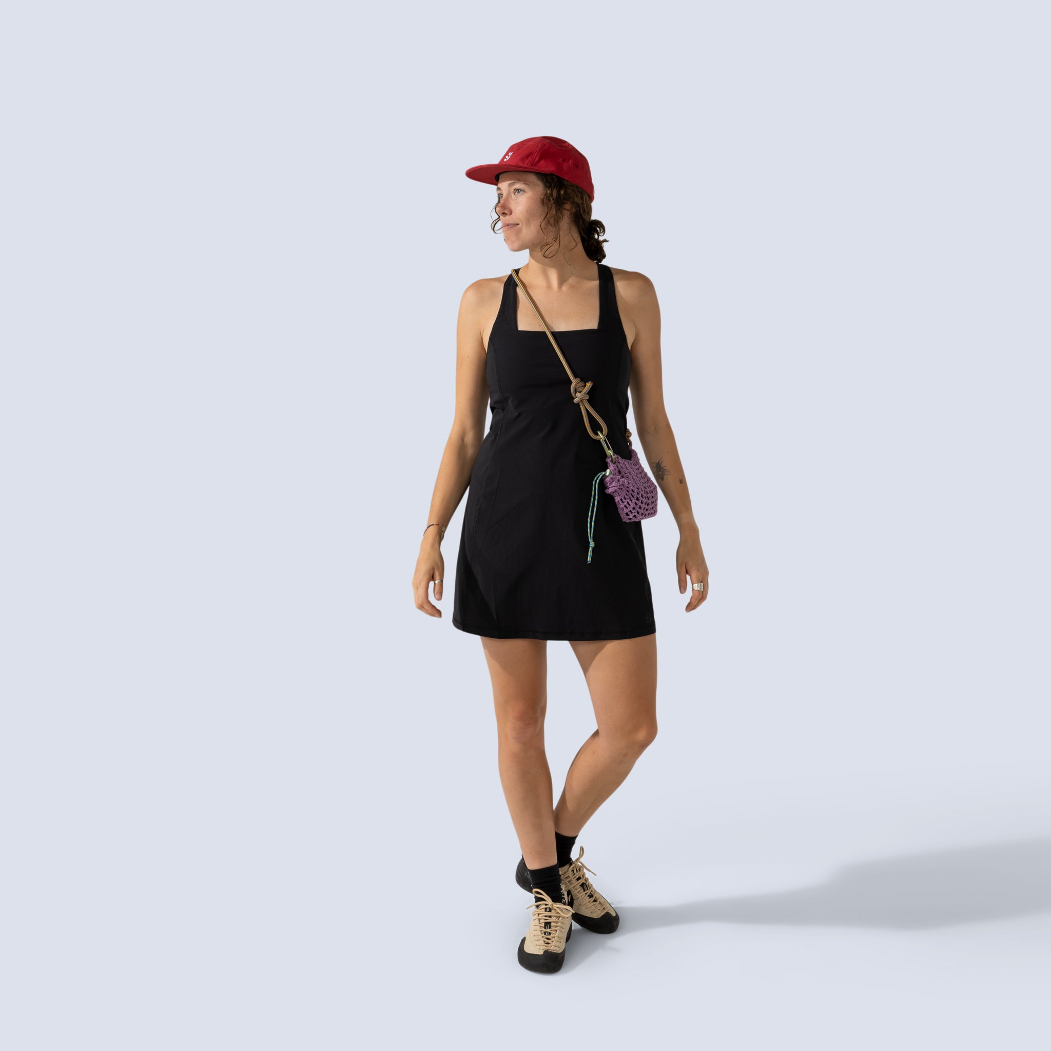[Black] Woman wearing black Parker dress, and red cap 