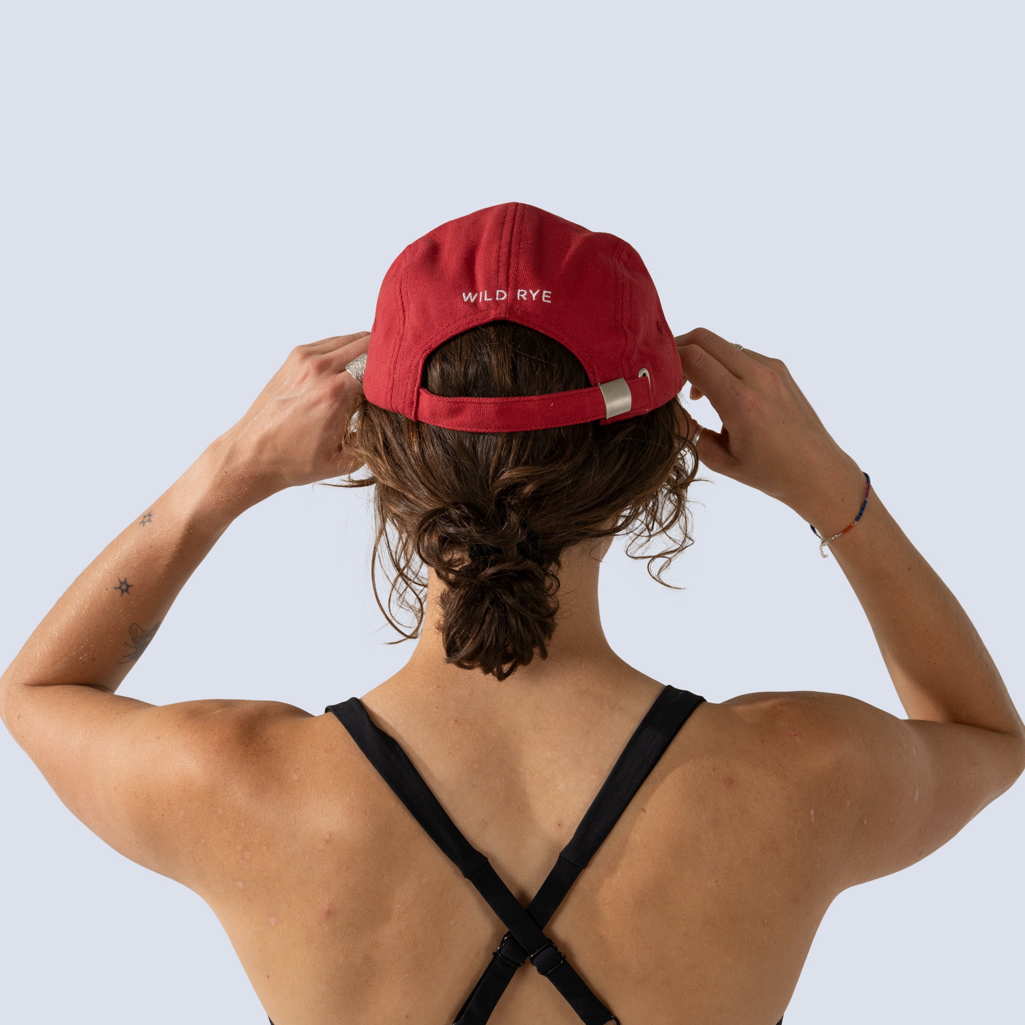 [Star Garnet] Back view of red baseball cap with "Wild Rye" text on back in white stitched font