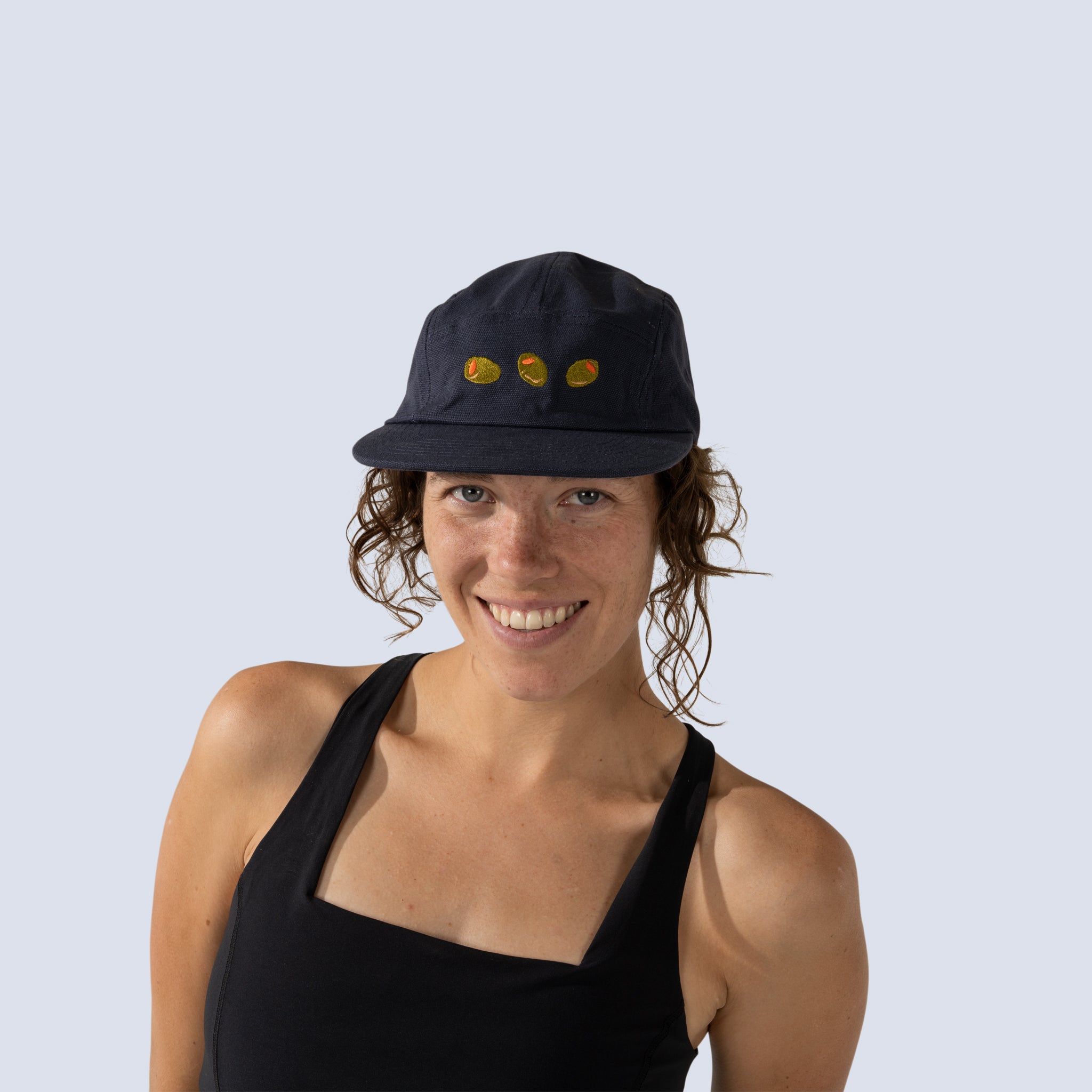 [Midnight Olives] Woman wearing navy blue baseball cap with olives on front