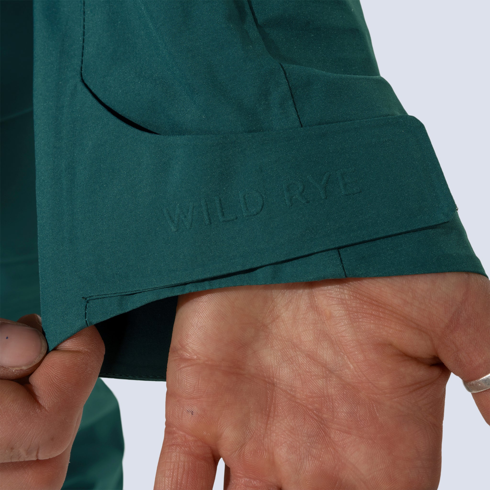 [Shaded Spruce] Heyburn 3L Jacket in shaded spruce, close up detail of "wild rye" branding on velcro wrist cuff