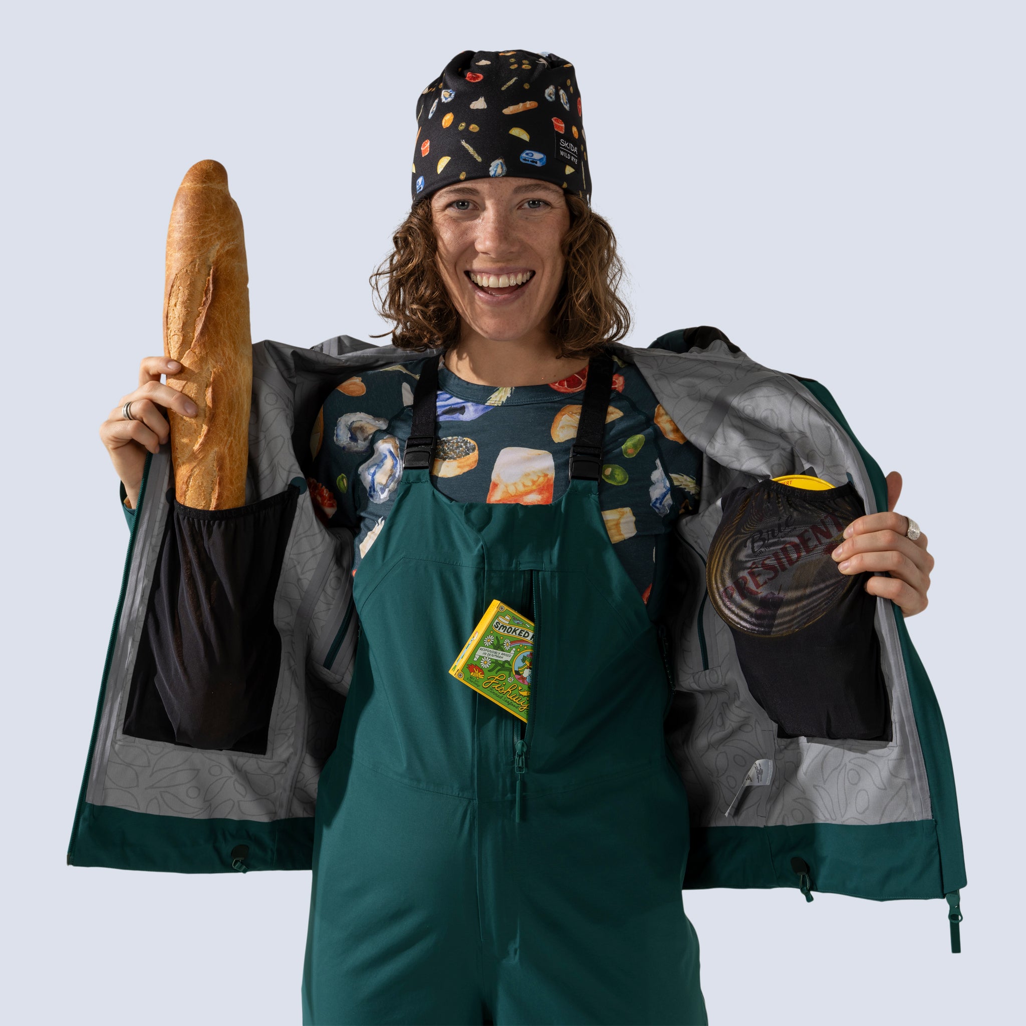 [Shaded Spruce] Heyburn 3L Jacket in shaded spruce, internal mesh stash pockets filled with snacks and a baguette