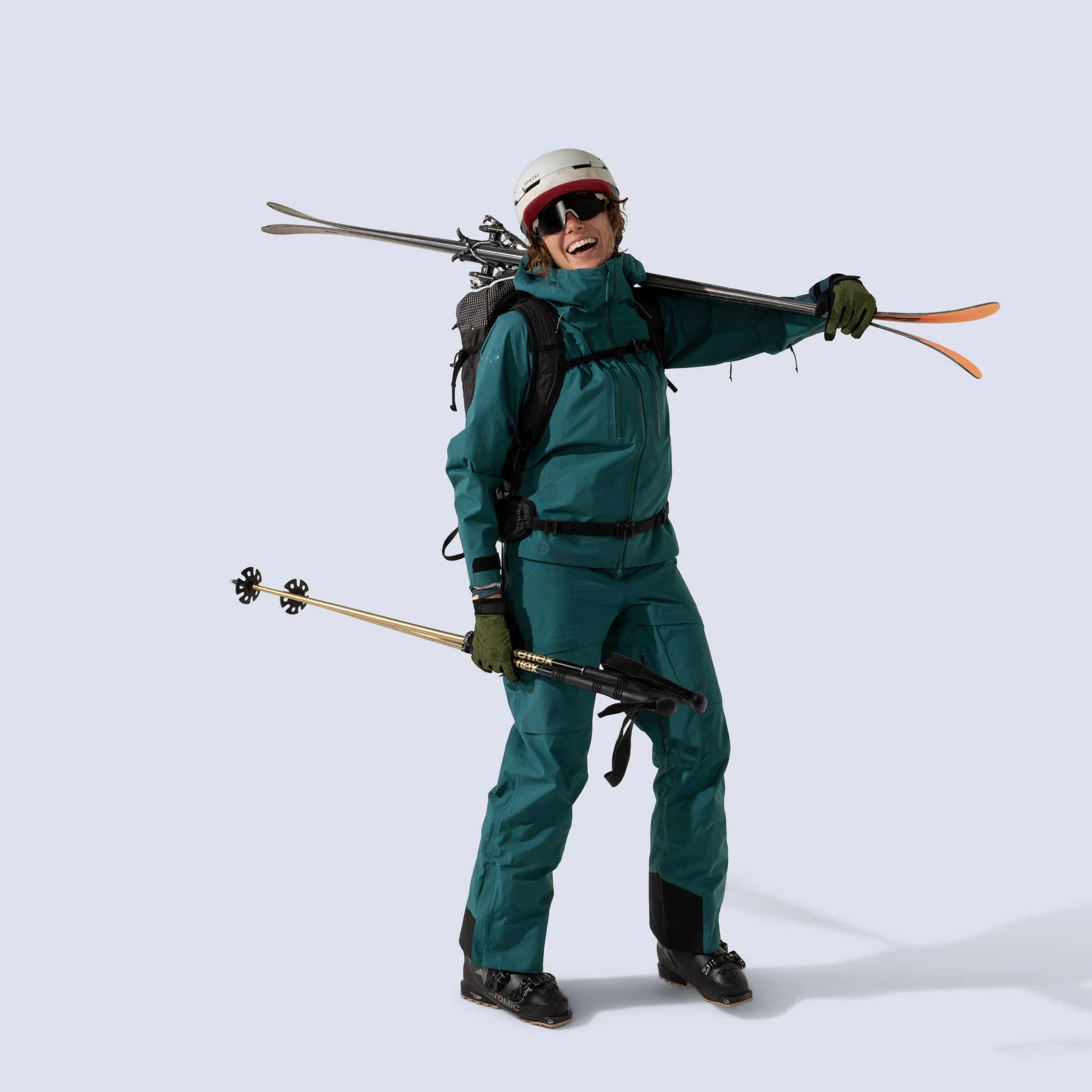 [Shaded Spruce] Heyburn 3l bibs in shaded spruce, on model front full body with matching heyburn 3l jacket carrying ski gear
