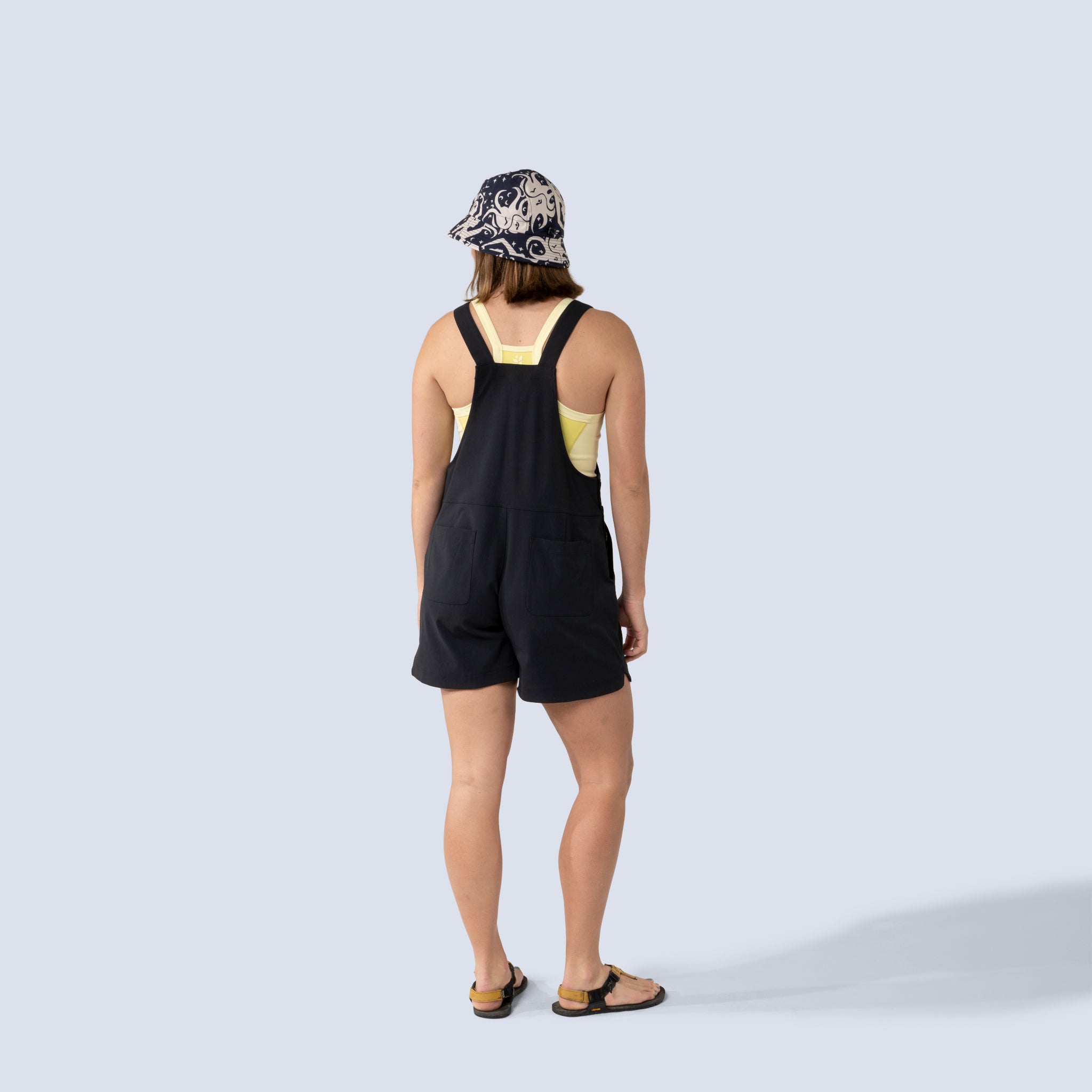 [Black] Eeva short overalls black, on model back full body view