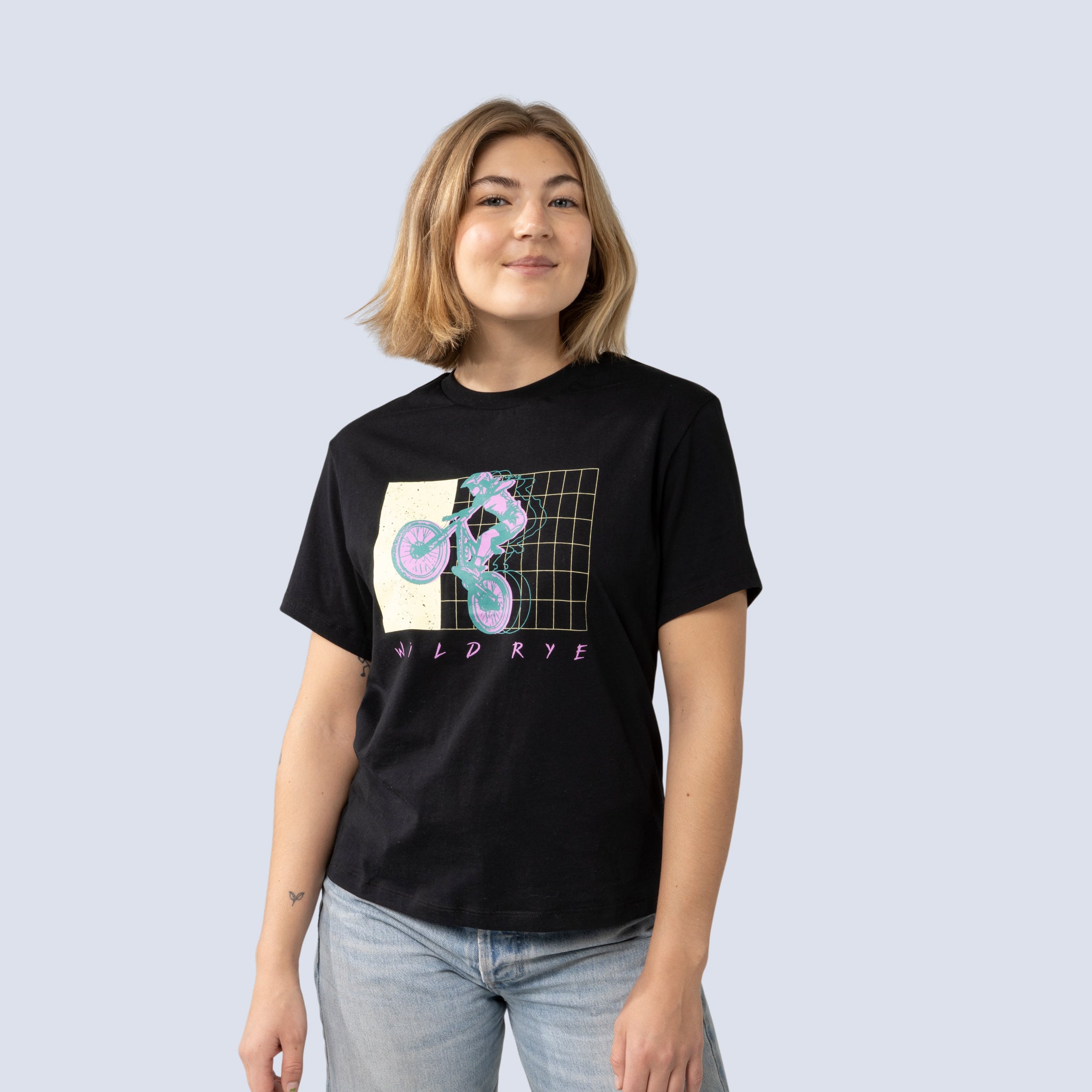 Person wearing a black t-shirt with a graphic design on a plain background