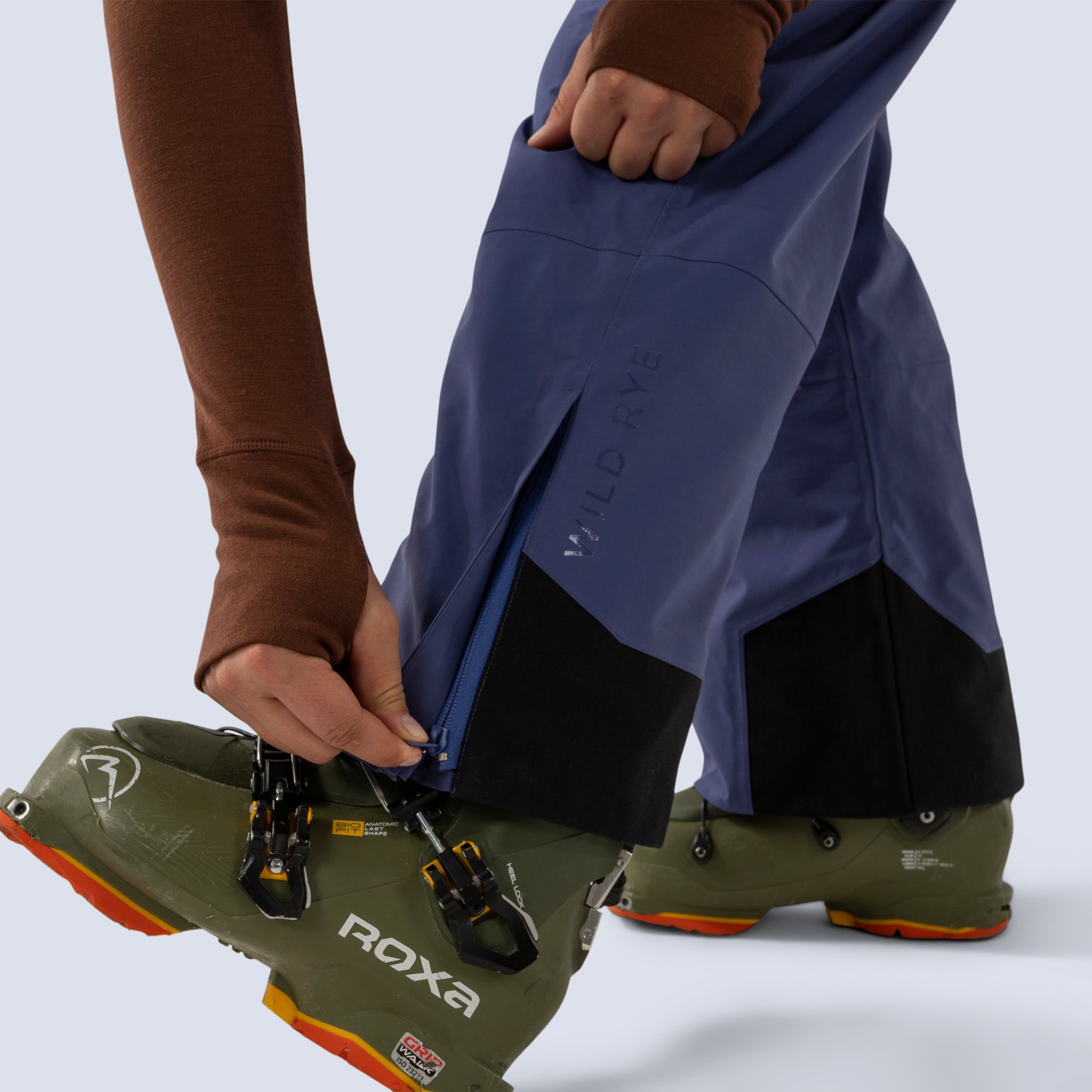 [Storm] Butterfield 3L pant in storm blue, zippered cuff detail with heat transfer "Wild Rye" branding on leg