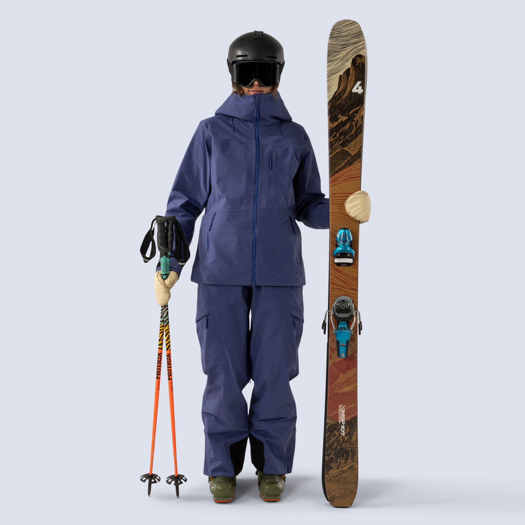 [Storm] Butterfield 3L jacket in storm blue, model holding skis and poles, looking at camera