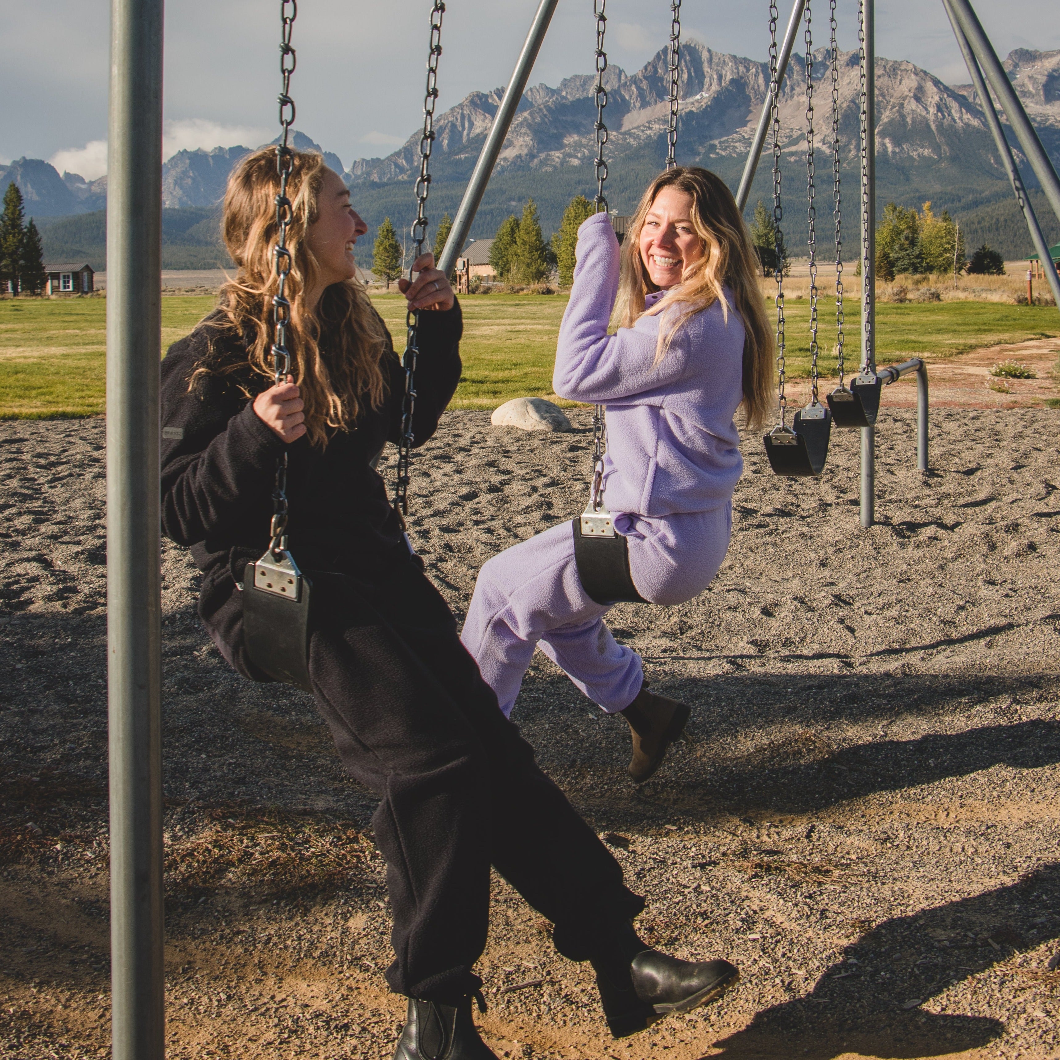 [Lilac] women on swingset wearing danner jogger and pullover