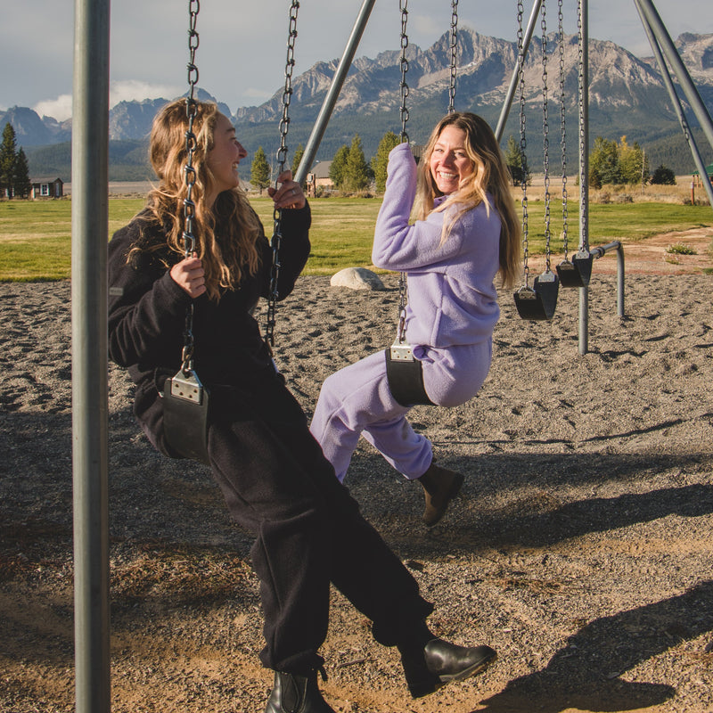 women on swingset wearing danner jogger and pullover