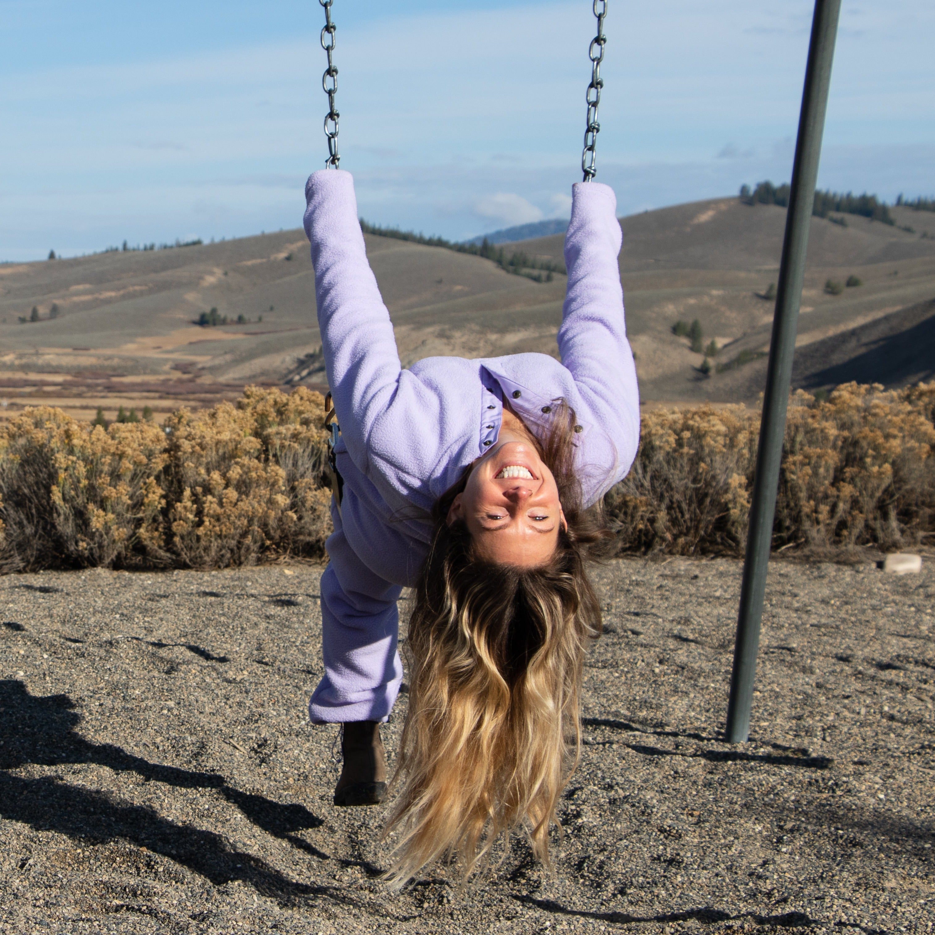 [Lilac] Woman on swingset wearing danner kit