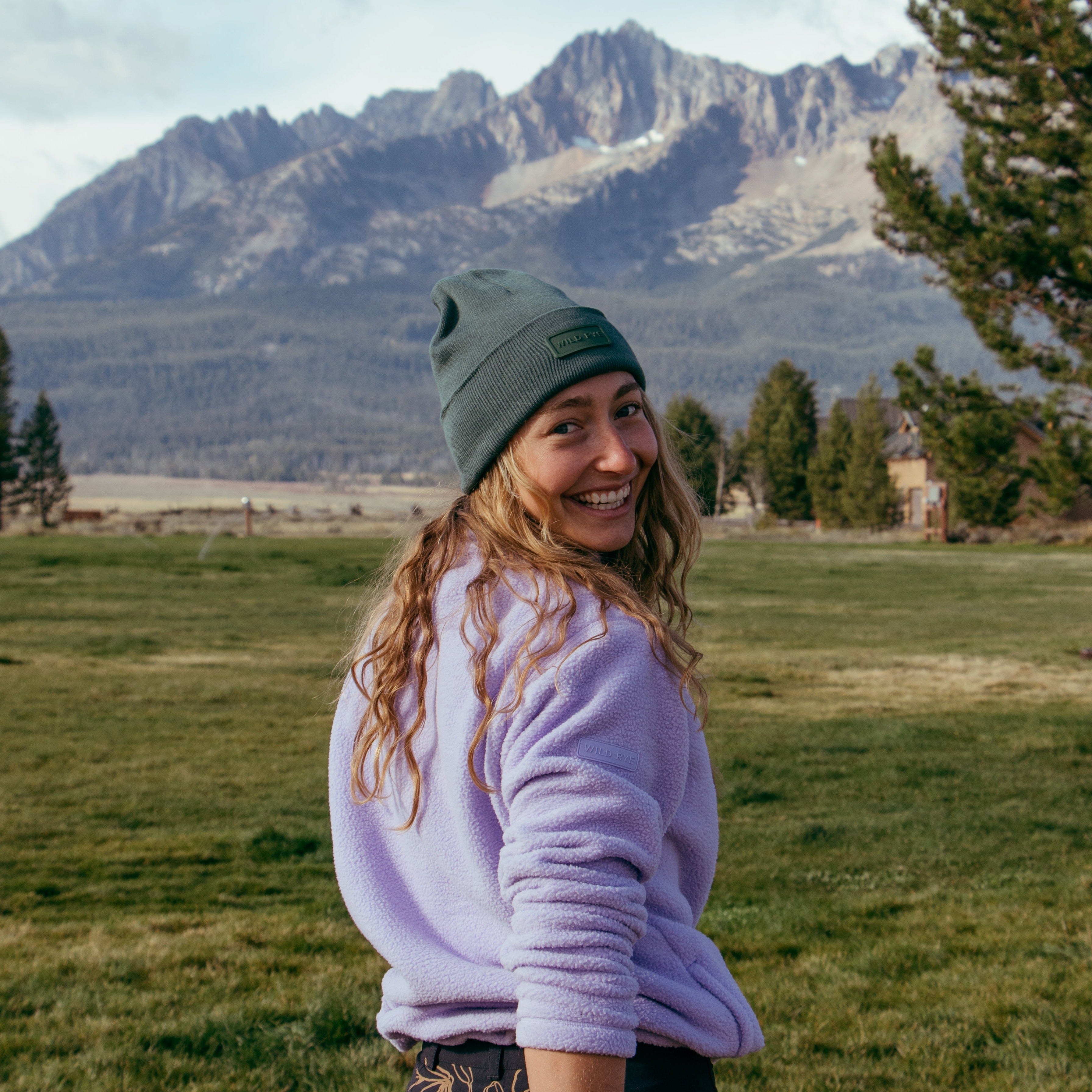 [Lilac] Woman smiling with mountains in the background