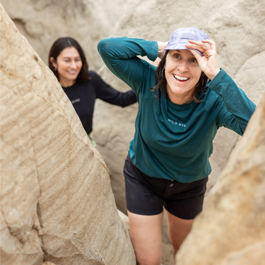 [Shaded Spruce] Woman hiking through a slot canyon