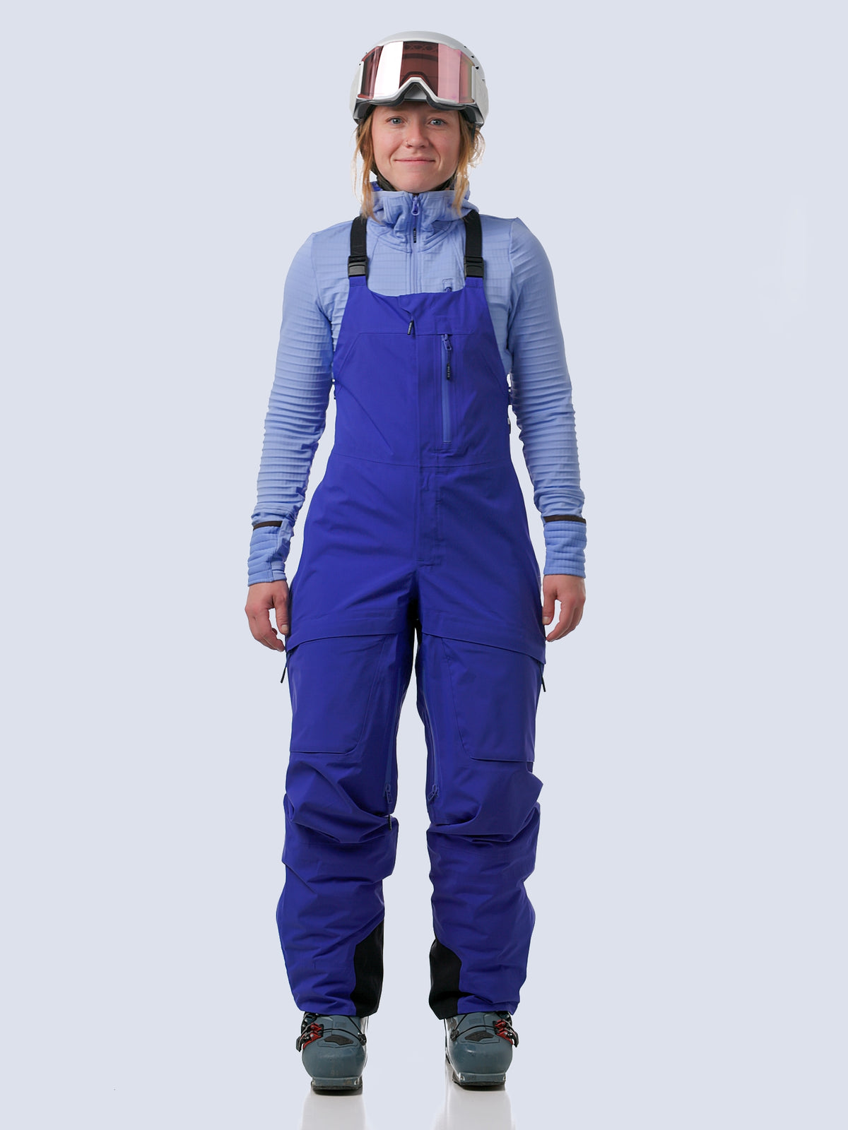 Woman walking into video with heyburn 3l bibs in lapis blue, turning, and walking out of frame