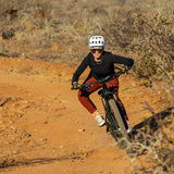 Woman cornering on mountain bike in sandia bike jersey