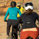Three women riding bikes in Sandia Bike Jerseys