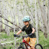 Girl biking through aspen trees