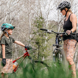 Girl and mother mountain biking together